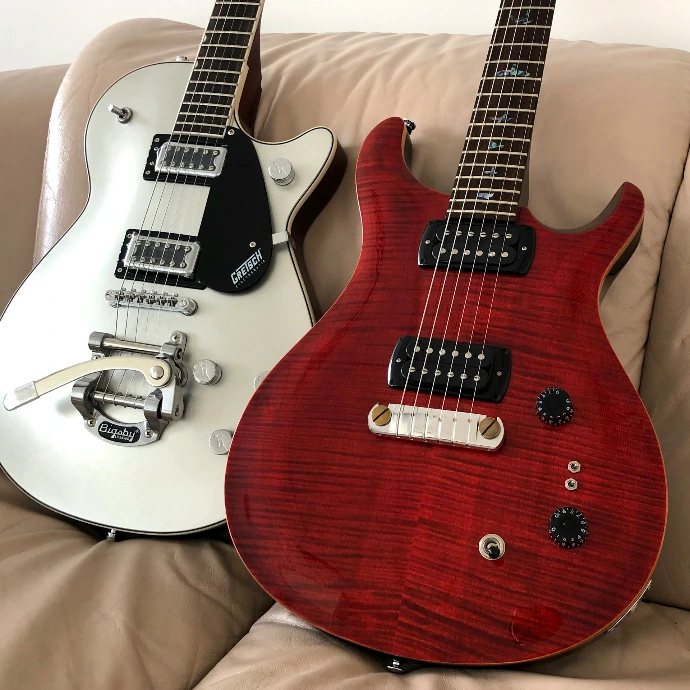 red and white stratocaster electric guitar